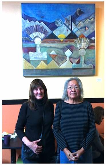 Photo: Photo: Carol Robinson-Zanartu poses with artist in front of painting on wall