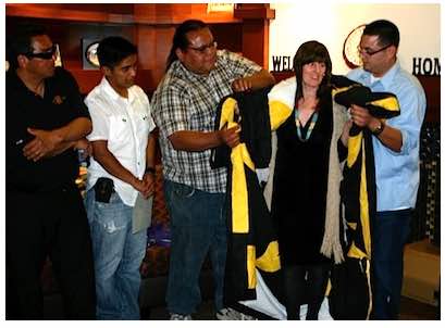Photo: Students drape Carol Robinson-Zañartu with star quilt