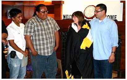 Photo: Students and Carol Robinson-Zañartu wearing star quilt